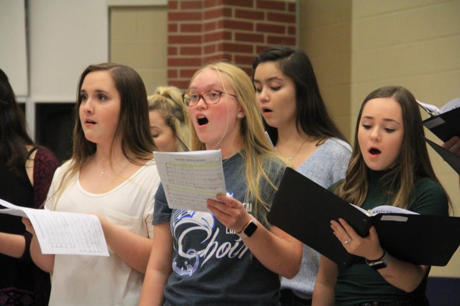 Choir sings during their annual potluck dinner before receiving their letter jackets.