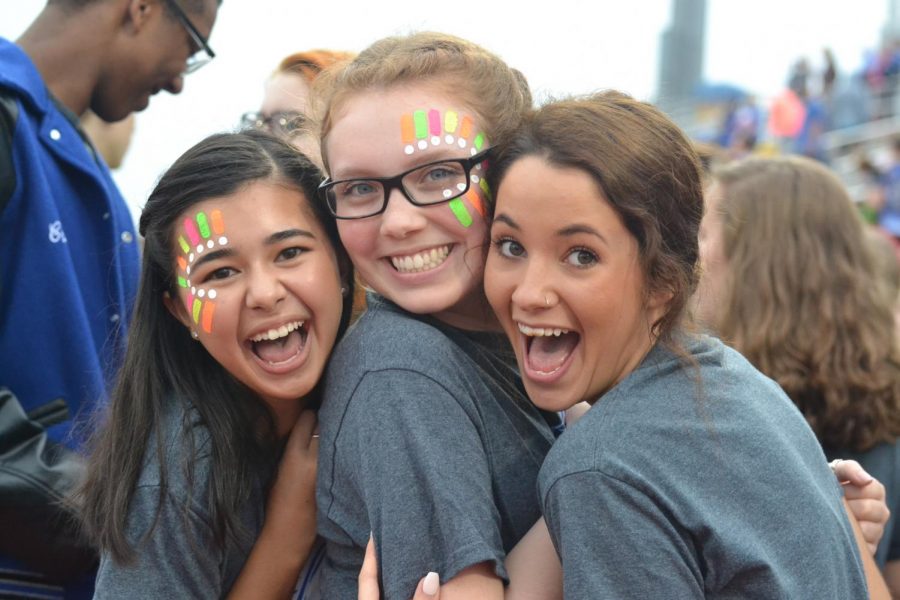 Choir paints their faces before they sing the National Anthem at the game against Katy on September 22