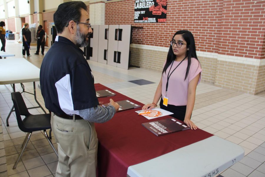 Students speak to college representatives during the college fair on Mane Street on September 27.