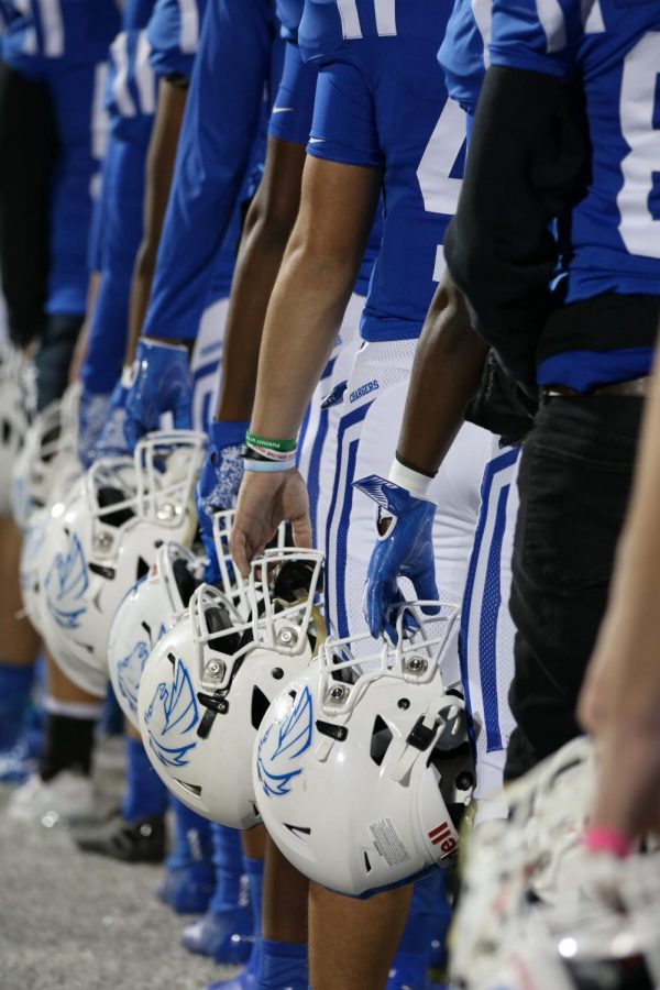 Varsity football players line up for the National Anthem at the game against Creek, which they won. Varsity will play Dawson in the first round of playoffs this Friday, November 18th. 